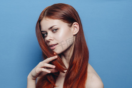 红发摄影照片_裸肩红发的女人魅力蓝色背景