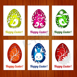 一套复活节贺卡，上面有五颜六色的彩蛋，木制背景上有剪纸风格。