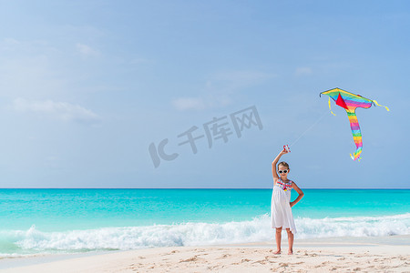 在海滩上放风筝的小女孩