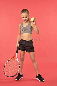 拿着网球拍和球的可爱的女孩