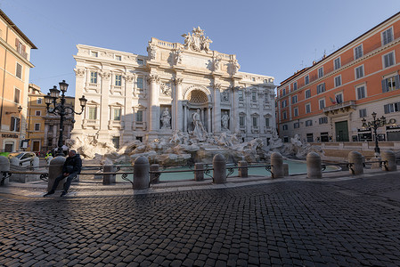 罗马假日摄影照片_坐在空无一人的特雷维喷泉，罗马，意大利的人