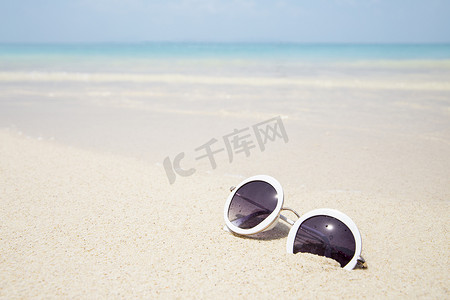 夏天蓝色大海沙滩上的太阳镜