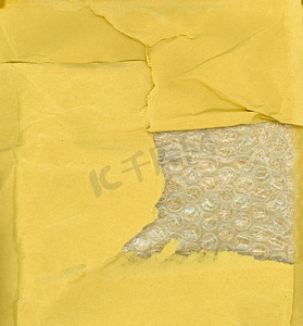 茶叶包装包装盒摄影照片_黄纸和气泡包装纹理背景