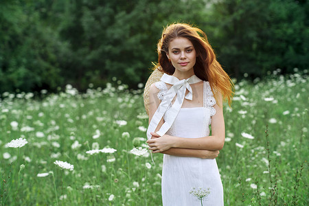 白裙摄影照片_田野里穿白裙的女人在复古的大自然中漫步