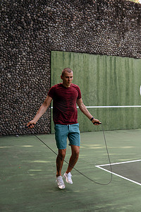 男子在网球场上跳绳