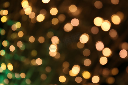 柔和的散景金黄色背景，散景金黄色五颜六色的圣诞快乐，新年快乐散景灯光在夜晚闪耀，散景闪光灯，金色奢华背景，闪闪发光的壁纸
