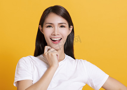 黄色背景的微笑亚洲年轻女性