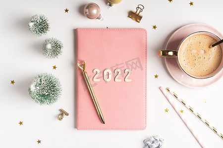 顶部视图桌面圣诞粉色记事本，带有 2021goals 字母文本。