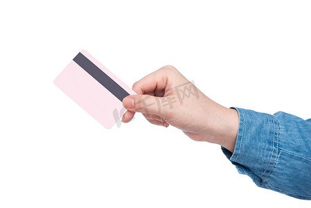 信用卡神器摄影照片_拿着桃红色信用卡的女性手。