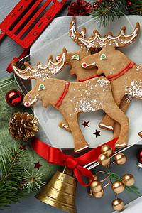 雪花麋鹿背景摄影照片_带装饰的圣诞姜饼麋鹿形饼干