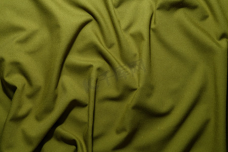 卡其色配色摄影照片_皱巴巴的橄榄绿皱巴巴的棕褐色卡其布帆布面料-全框背景和质地
