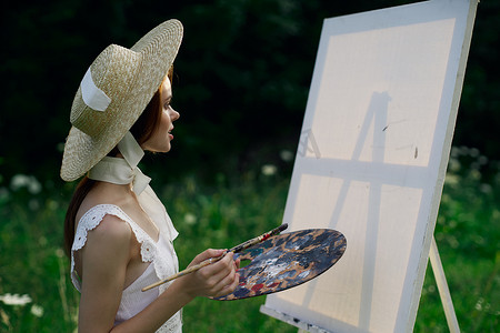 白裙摄影照片_穿白裙的女人艺术家画架画自然风景