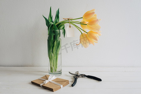 用剪枝刀剪下的郁金香立在玻璃花瓶里。