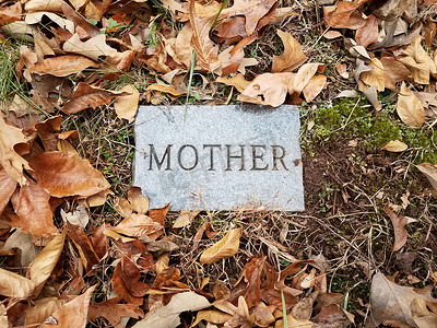 带有母亲和落叶的墓碑或标记