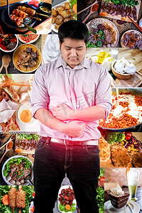 肝痛摄影照片_一个男人因为吃太多食物而胃痛