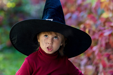 穿着女巫服装的小女孩在万圣节派对上做出不同的面孔