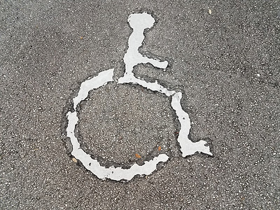 沥青上的白色轮椅或残疾人标志