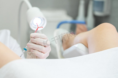 健康摄影照片_妇科医生在将 IUD 节育器用于患者之前拿着它