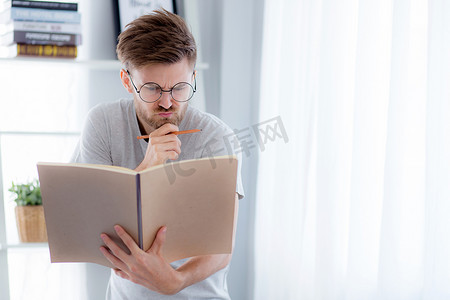 眼镜的帅哥正在看书准备考试和 th