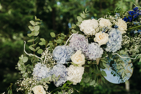 鲜花拱门摄影照片_婚礼在绿色草坪的街道上举行。仪式用鲜花拱门装饰