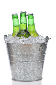 啤酒瓶摄影照片_冰中的三个绿色啤酒瓶