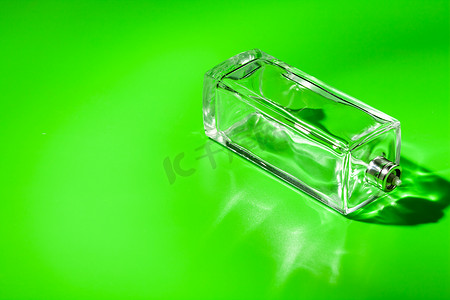 浅绿色背景上的香水玻璃瓶。