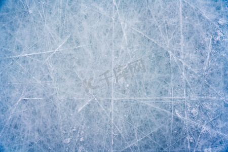 冰背景摄影照片_带有滑冰和曲棍球痕迹的冰背景，带有划痕的溜冰场表面的蓝色纹理