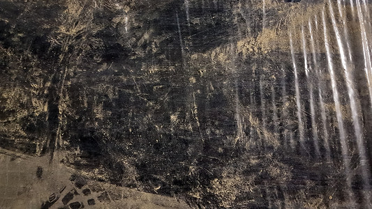 尘土中肮脏的黑色聚乙烯的抽象背景。
