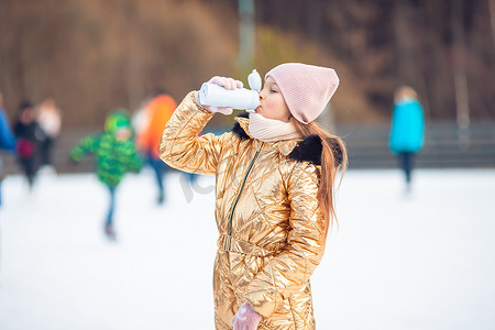 可爱的小快乐女孩在下雪的冬天雪橇。