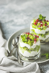 酸奶燕麦摄影照片_由格兰诺拉麦片、酸奶和猕猴桃制成的健康膳食。