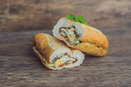 长萝卜摄影照片_木质背景中美味的越南 Bahn Mi 三明治
