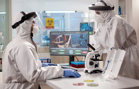 穿着 ppe 套装的生物技术科学家在设备齐全的实验室进行研究