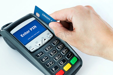 刷支付摄影照片_手用信用卡刷卡终端进行销售。