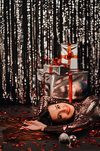 一个女孩穿着闪亮的衣服躺在地板上的头像，上面是五彩纸屑，上面是心形和礼物