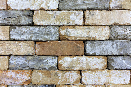建筑石材摄影照片_旧砖石墙的纹理，砂岩建筑石材。