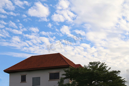 背景天空，图像底部有房屋，图片大，家庭屋顶和树，蓝天上的景观地产村