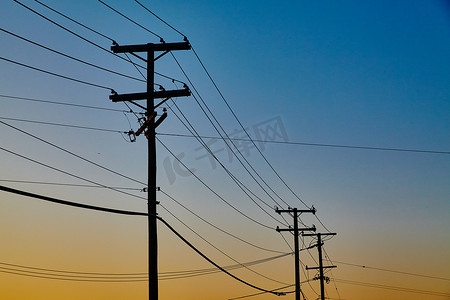 电源线延伸到远处，橙色夕阳映衬下