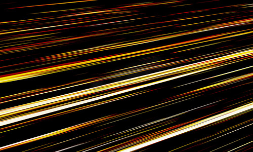 电脑壁纸摄影照片_金光撕裂线和条纹在黑暗中快速移动。