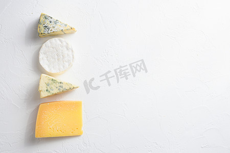奶酪拼盘：白色背景上的黄色 Maasdam、白色 Camembert 和蓝色奶酪 Dor Blue。