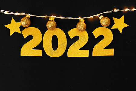 闪闪金星摄影照片_2022 年的概念。纸背景上的金星和数字 2022