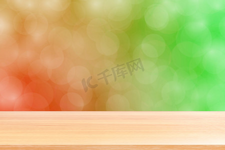 模糊散景软红绿色渐变背景上的空木桌地板，绿色散景彩色浅色上空的木板，彩色散景灯渐变软用于横幅广告产品