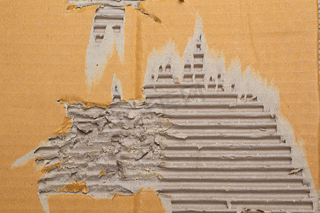 撕破的瓦楞纸棕色纸板抽象背景、用于设计艺术作品的回收纸盒的纹理。