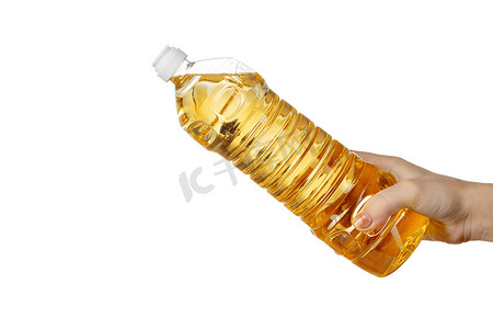 倒油瓶摄影照片_从塑料瓶倒食用油的女人的手。