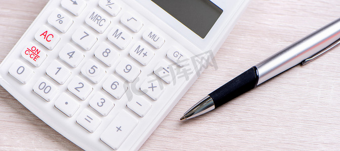 财务分析表格摄影照片_明亮木桌上的白色计算器和笔、财务利润分析和统计、投资风险概念、复制空间、顶视图平躺