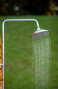 清爽浴室摄影照片_户外淋浴头贴在木板杆上设计用于淋浴