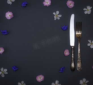 黑色背景中的铁制老式餐具叉子和刀子