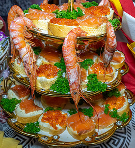 装饰虾摄影照片_虾和三明治配以绿色装饰的红色鱼子酱
