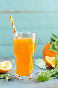 玻璃橙汁和木制背景叶子的新鲜水果、维生素饮料或鸡尾酒