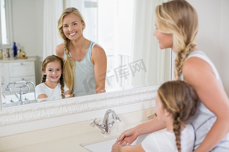 免水洗手液标识摄影照片_快乐的母女在浴室水槽洗手