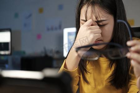 加班摄影照片_年轻女子加班，感觉眼睛疲劳。